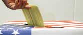 A voter casts his ballot as absentee voting gets underway in the US Presidential election